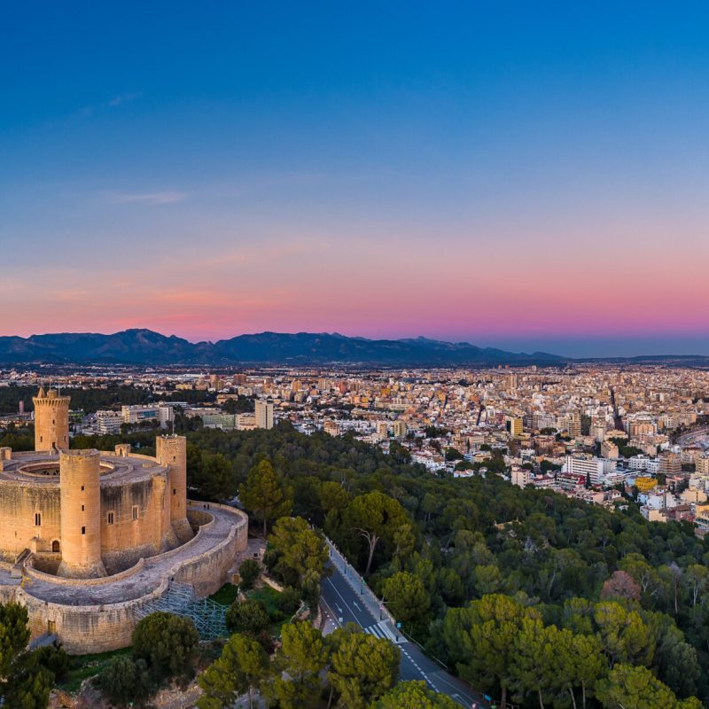 Aerial view of Bellver Castle in Palma de Mallorca with the city in the background, highlighting architecture and design