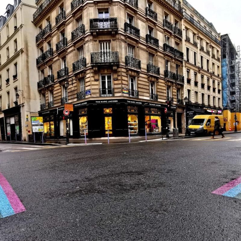 Street in The Marais, Paris, adorned with the LGTBIQ+ pride flag, showcasing a vibrant and inclusive atmosphere