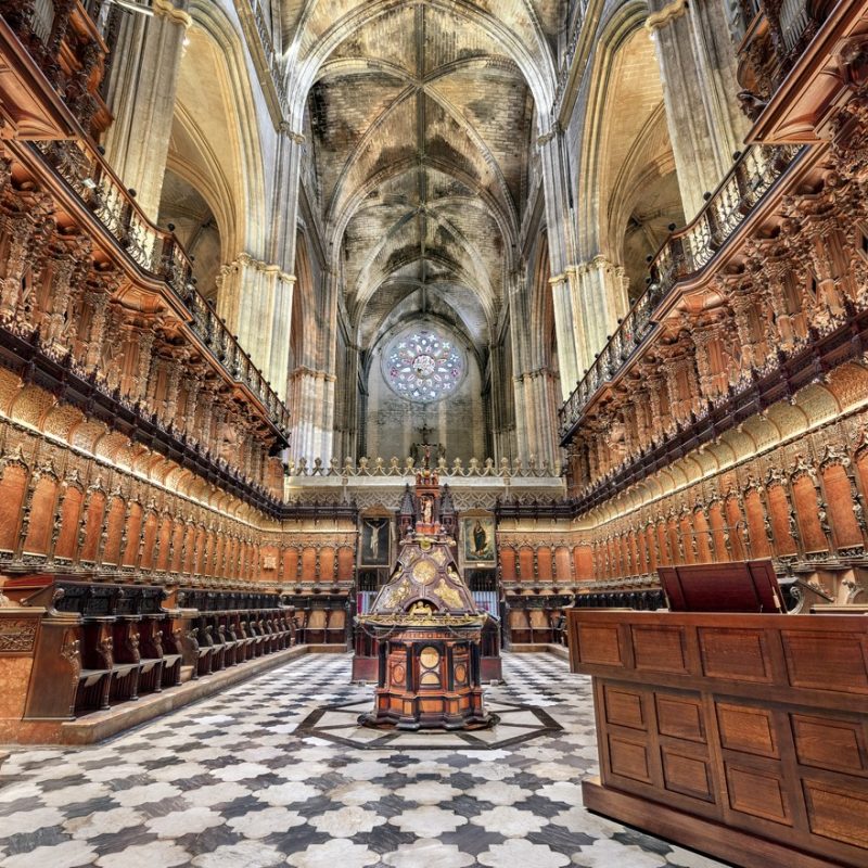 Interior view of Seville Cathedral, showcasing its grand Gothic architecture and intricate details