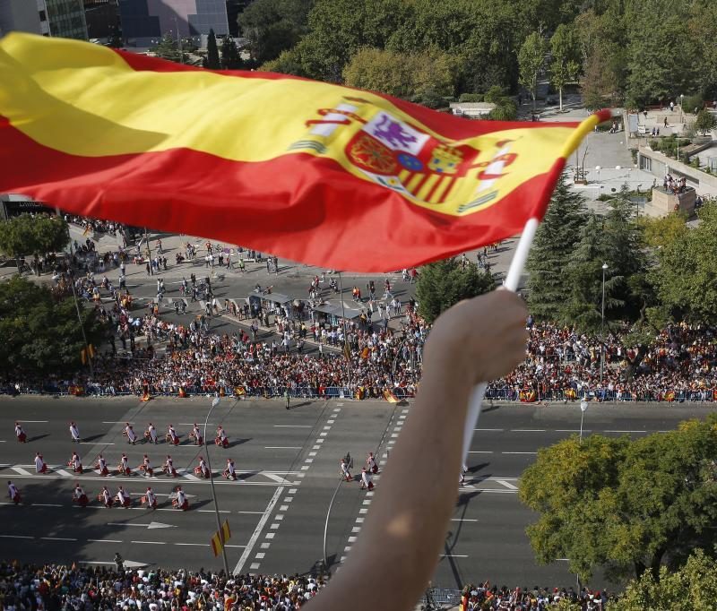 A person’s arm waving the Spanish flag from the top of a building, celebrating the spirit of the event