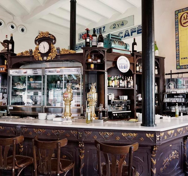 Interior of a traditional bar in Seville, showcasing vintage decor and a cozy atmosphere that reflects the history of one of the city's oldest establishments