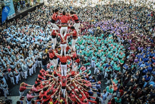 People building human towers (castells) during the Fiestas de Santa Eulalia in Barcelona, showcasing tradition and teamwork