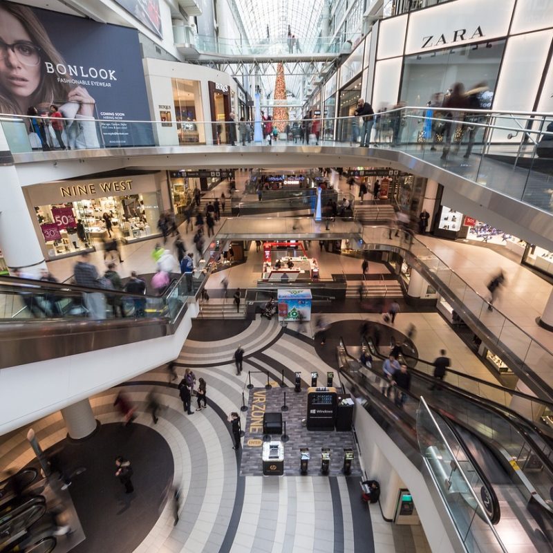 Interior of a shopping mall in Madrid with various stores and shoppers
