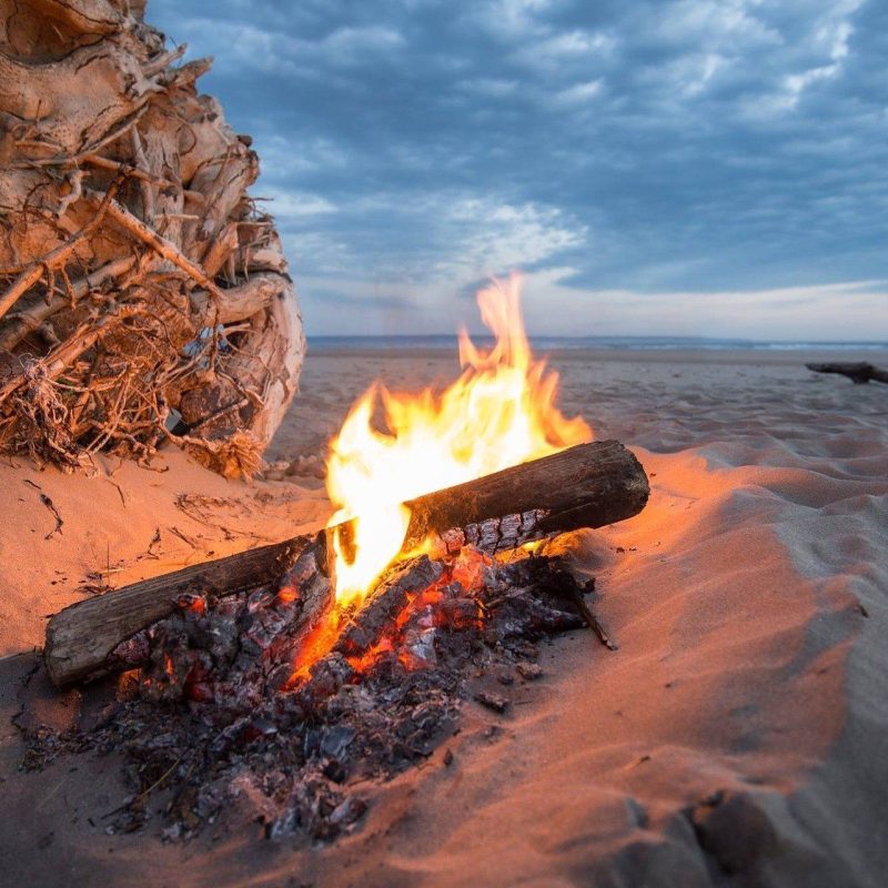 Small bonfire on the beach during the magical celebration of the Night of San Juan in Barcelona