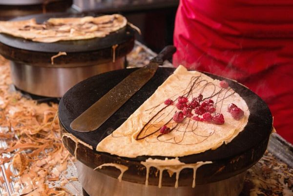 A freshly made crêpe cooking in a skillet in a Parisian kitchen
